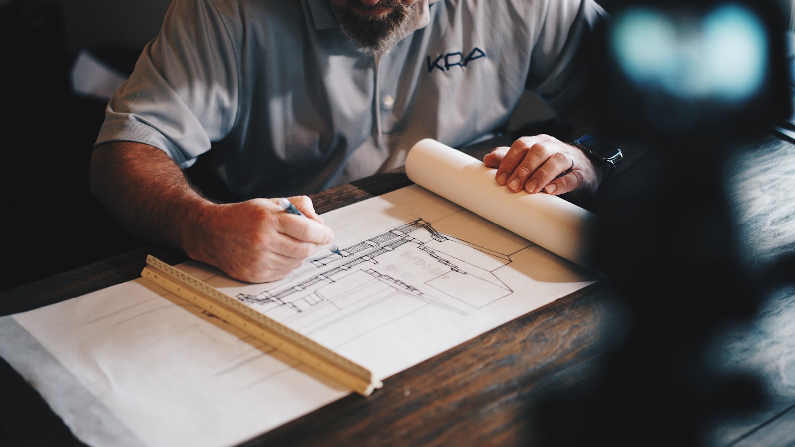 Architectural blueprint being drafted by hand